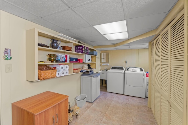 washroom with washing machine and clothes dryer and sink