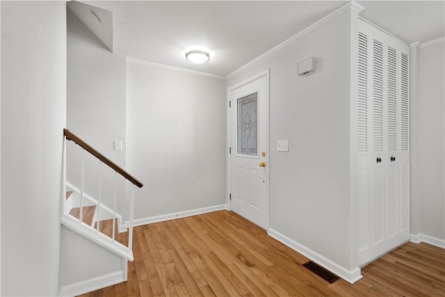 entrance foyer featuring hardwood / wood-style floors and ornamental molding