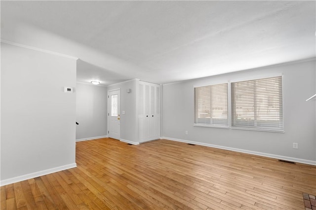 unfurnished room featuring crown molding and light hardwood / wood-style flooring