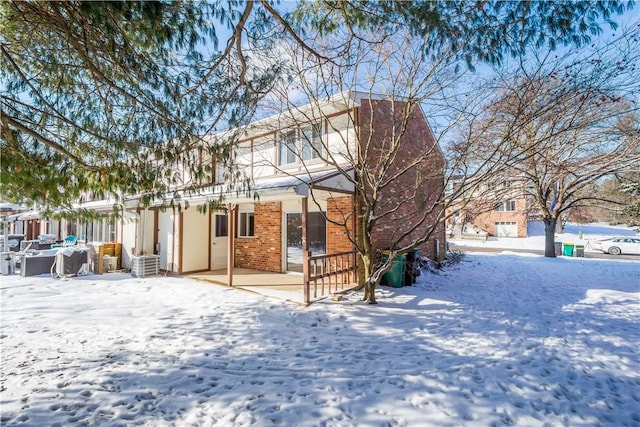 view of snow covered rear of property