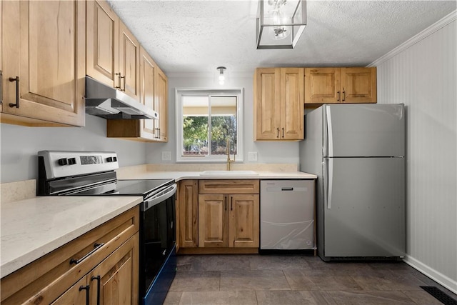 kitchen with a textured ceiling, appliances with stainless steel finishes, crown molding, and sink