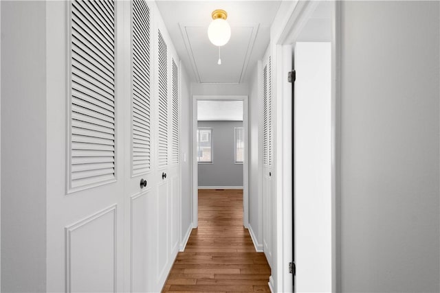 corridor with wood-type flooring