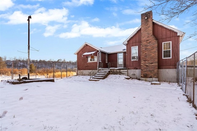 view of snow covered back of property