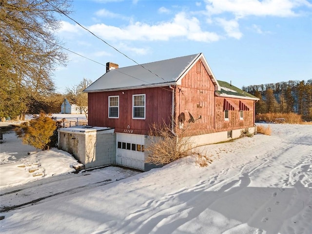 view of snow covered exterior featuring a garage