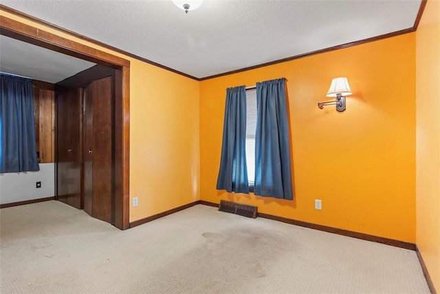 unfurnished room with light carpet and crown molding