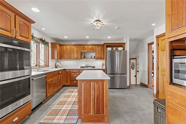 kitchen with sink, a kitchen island, backsplash, and appliances with stainless steel finishes