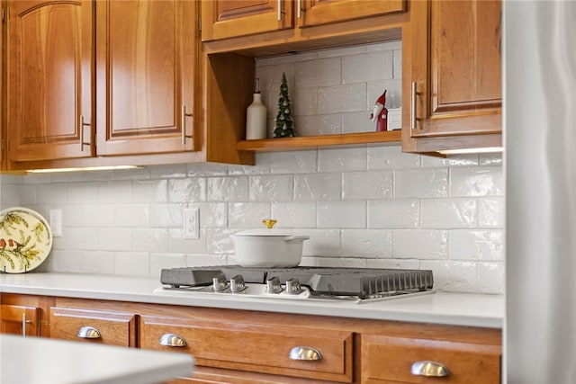 kitchen with tasteful backsplash and appliances with stainless steel finishes