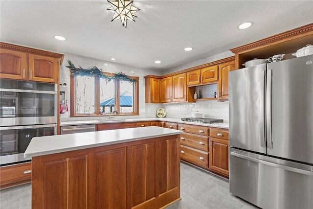 kitchen featuring sink, a center island, light tile patterned flooring, decorative backsplash, and appliances with stainless steel finishes