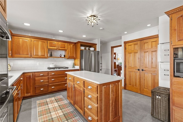 kitchen with tasteful backsplash, stainless steel appliances, and a kitchen island