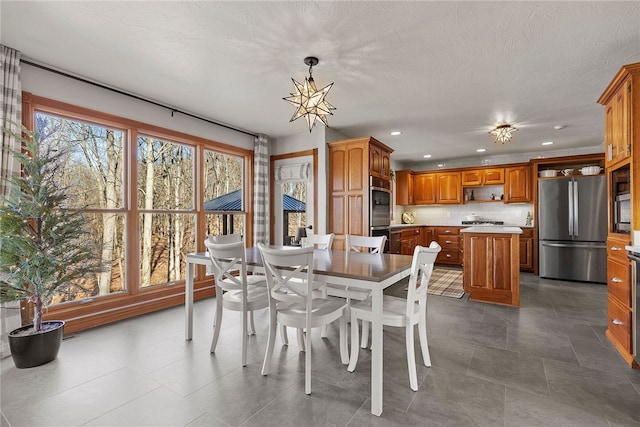 dining area featuring an inviting chandelier and a wealth of natural light