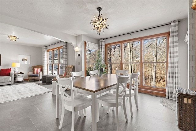 dining space featuring an inviting chandelier