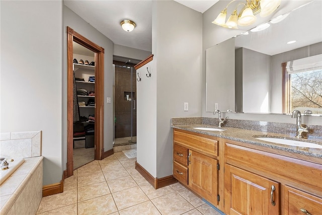 bathroom featuring shower with separate bathtub, vanity, and tile patterned floors