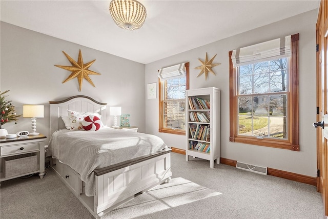 carpeted bedroom featuring multiple windows