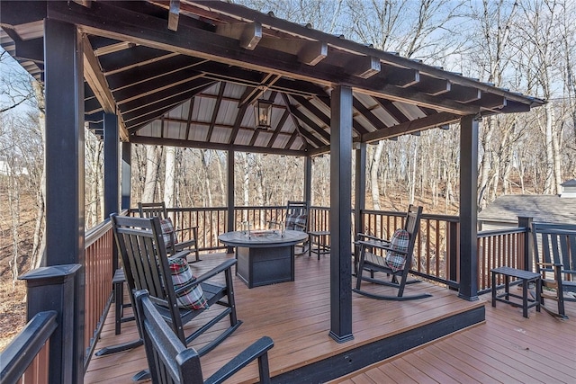 deck featuring a gazebo and a fire pit