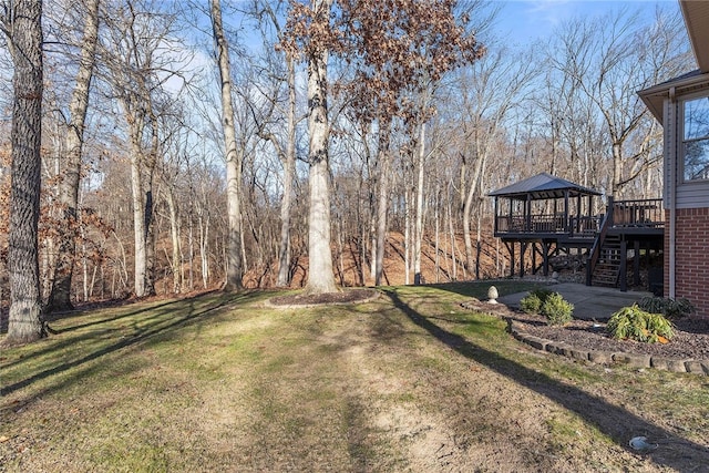 view of yard featuring a gazebo, a patio area, and a wooden deck