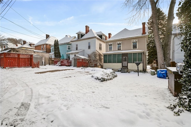 view of snow covered rear of property