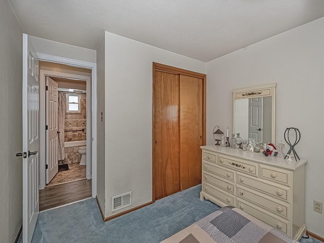 bedroom with a closet and dark colored carpet