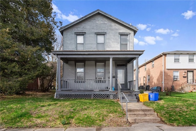 traditional-style home with a porch and a front lawn
