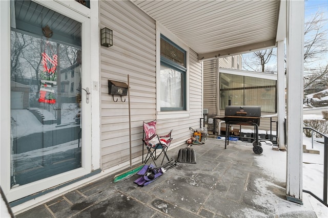 snow covered patio featuring grilling area