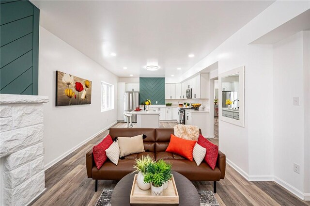 living room featuring sink and hardwood / wood-style floors