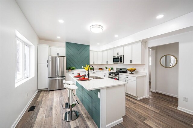 kitchen featuring appliances with stainless steel finishes, white cabinetry, and sink