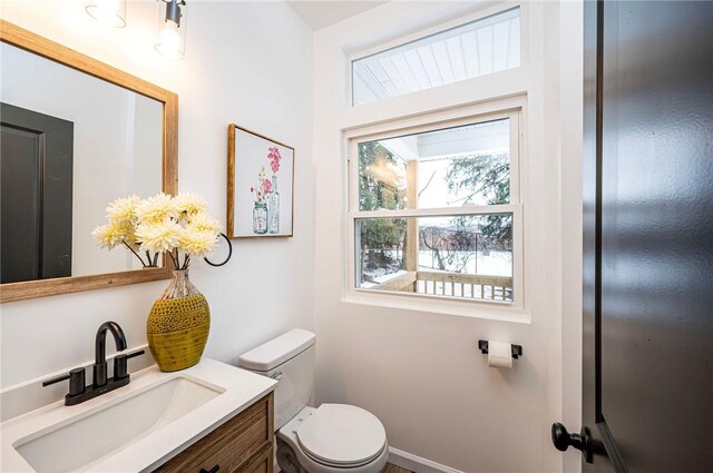 bathroom featuring toilet and vanity