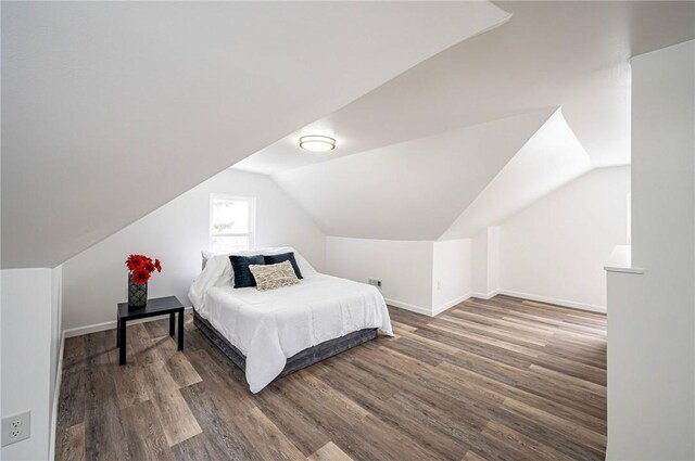 bedroom featuring lofted ceiling and hardwood / wood-style floors