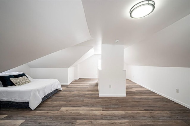 bedroom featuring vaulted ceiling and dark hardwood / wood-style floors