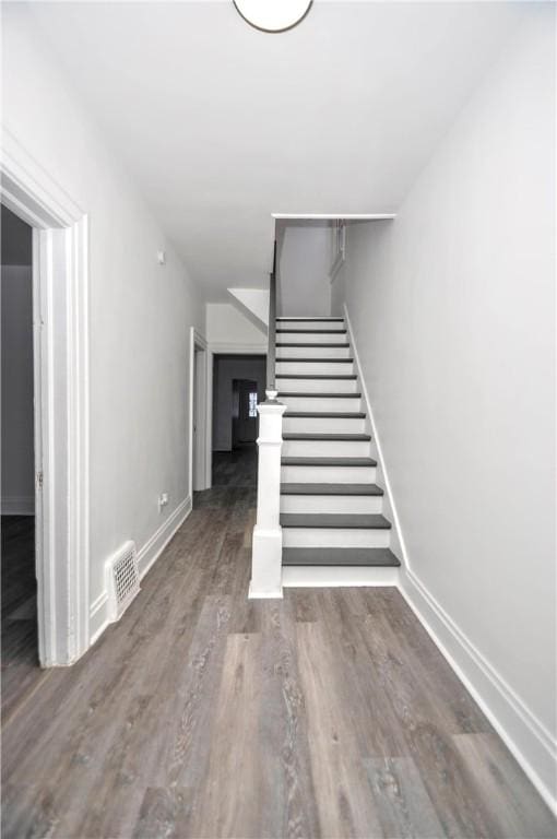 stairway with hardwood / wood-style floors