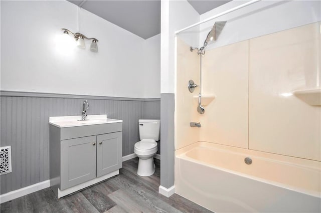 full bathroom with toilet, shower / bath combination, wood-type flooring, and vanity