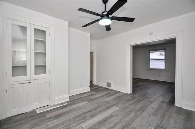 spare room with ceiling fan and dark hardwood / wood-style flooring