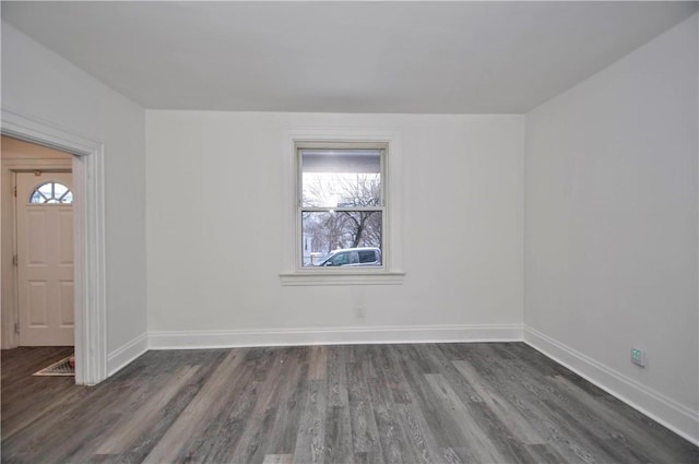 unfurnished room with dark wood-type flooring