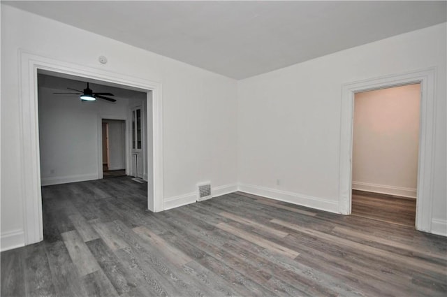 empty room featuring dark wood-type flooring and ceiling fan