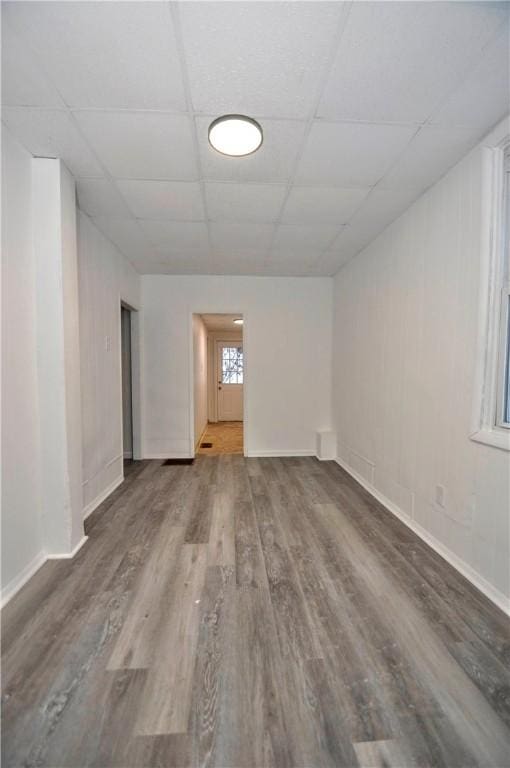 spare room with a drop ceiling and hardwood / wood-style floors