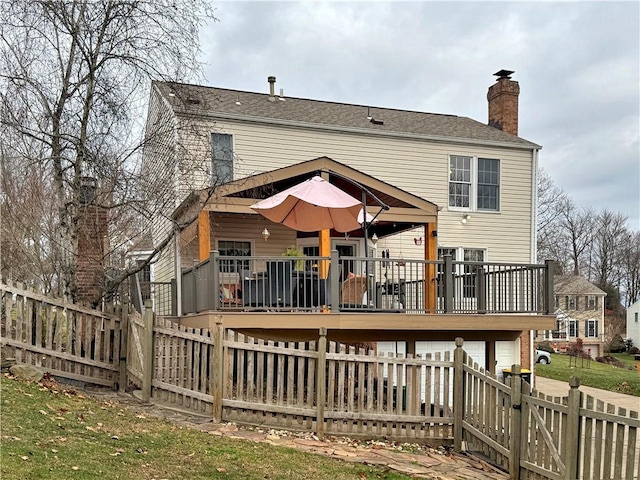 back of house with a wooden deck