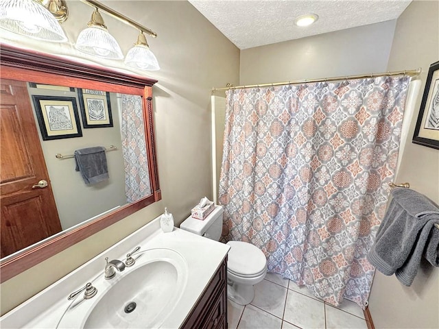 bathroom with toilet, vanity, tile patterned floors, a textured ceiling, and a shower with shower curtain