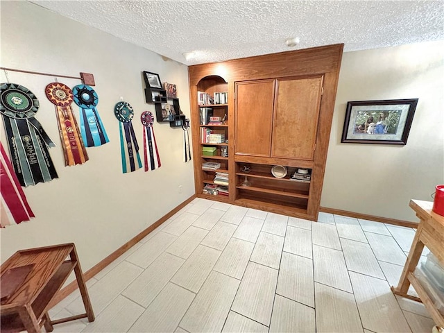 interior space with a textured ceiling and built in features