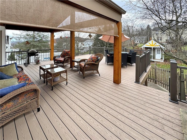 wooden terrace with outdoor lounge area and grilling area