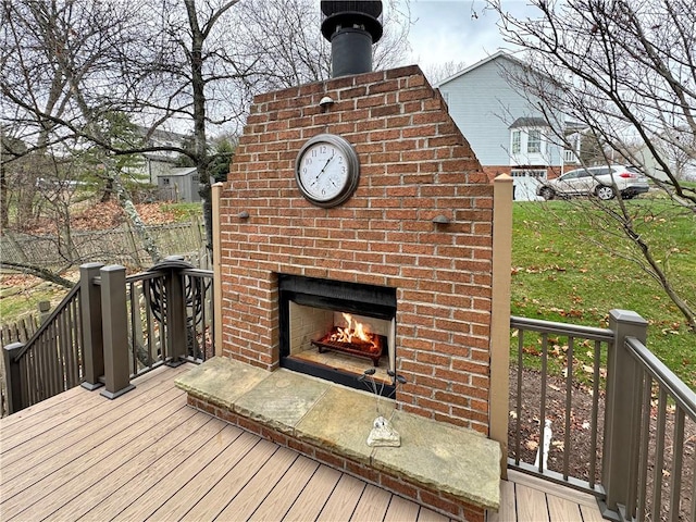 deck featuring an outdoor brick fireplace