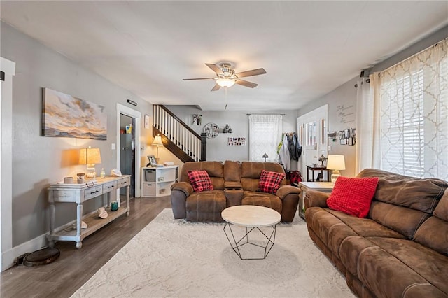 living room with ceiling fan and dark hardwood / wood-style flooring