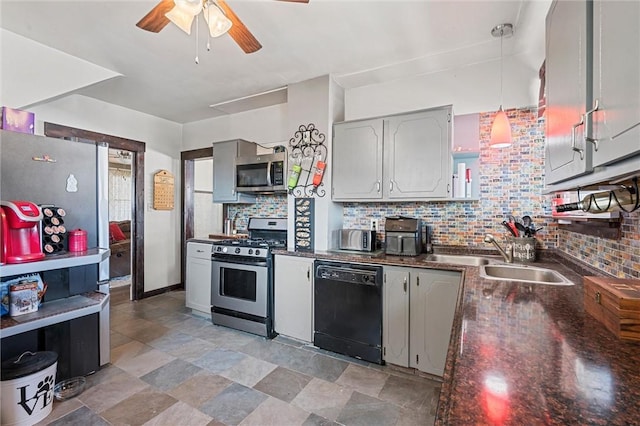 kitchen featuring sink, decorative backsplash, gray cabinets, pendant lighting, and appliances with stainless steel finishes