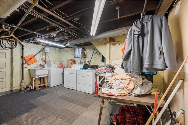 basement featuring washer and dryer and sink