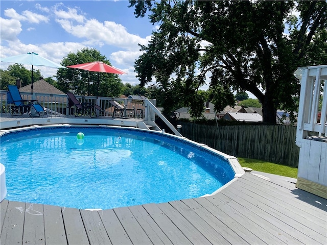 view of swimming pool with a deck