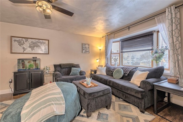 living room featuring wood-type flooring and ceiling fan