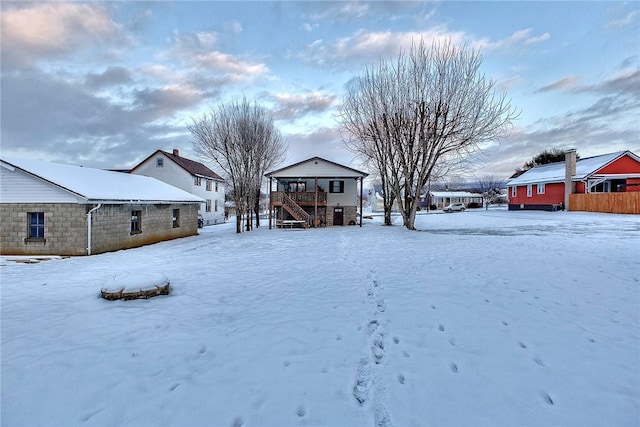 yard layered in snow with a deck