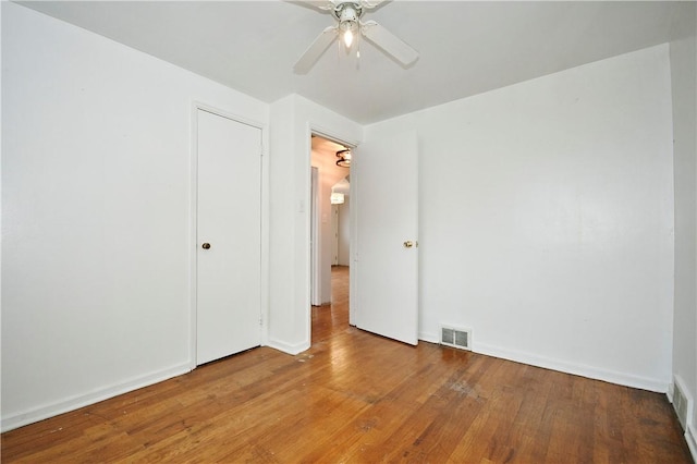 spare room with wood-type flooring and ceiling fan