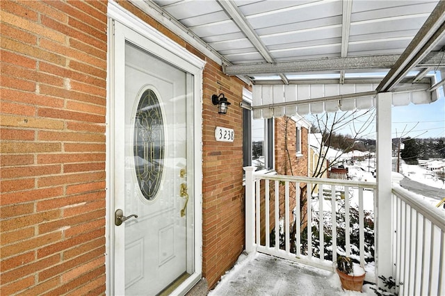 view of snow covered property entrance