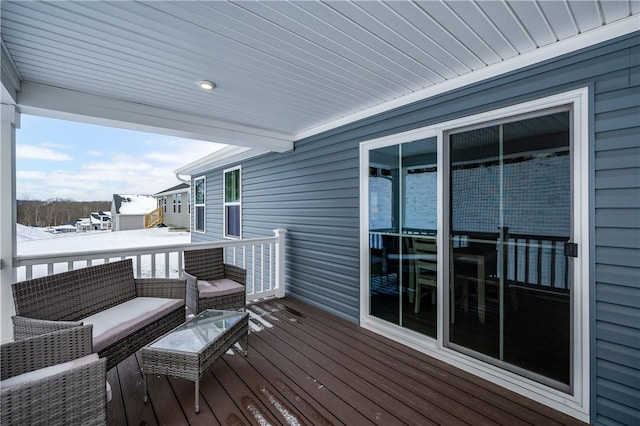 snow covered deck with an outdoor hangout area