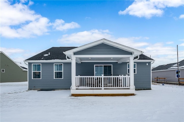 snow covered house with covered porch