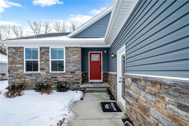 view of snow covered property entrance